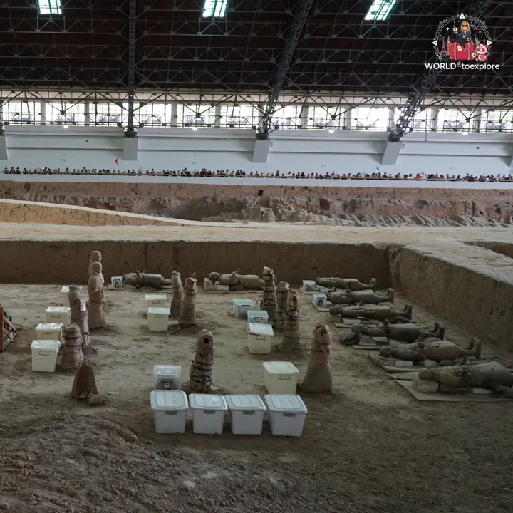 Excavation area with broken terracotta warriors, being restored