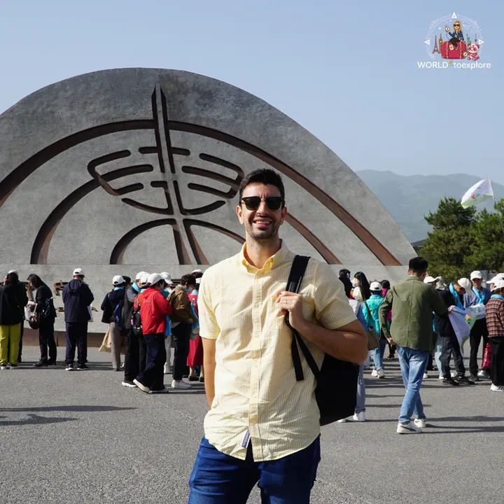 My partner next to the entrance monument of the Terracotta Army complex, in Xi'an