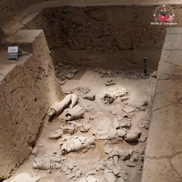 Fragments of terracotta warriors on the brick floor of a pit yet to be restored