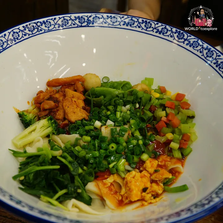 Bowl of wide Xi'an noodles with vegetables, at the complex's restaurant