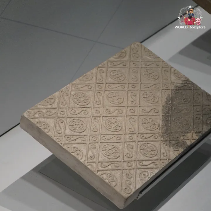 Decorated brick with geometric patterns on display at the Terracotta Army museum